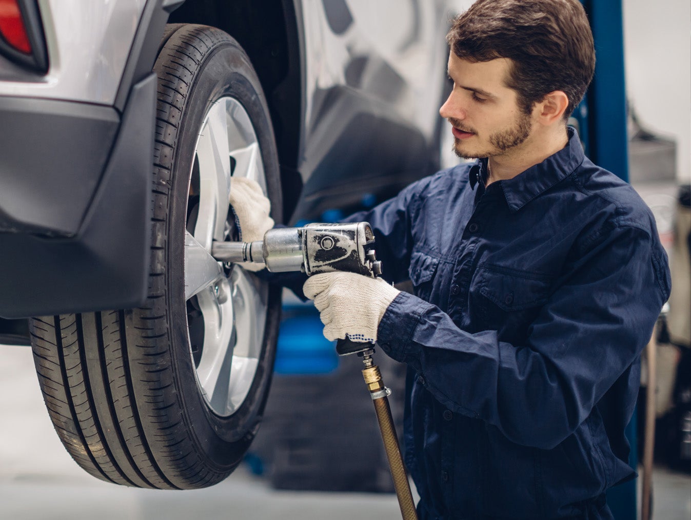 Automotive service technician performing vehicle maintenance